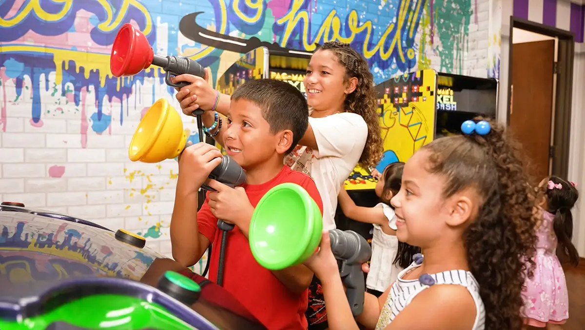 Kids playing arcade games at Rodeo Dental