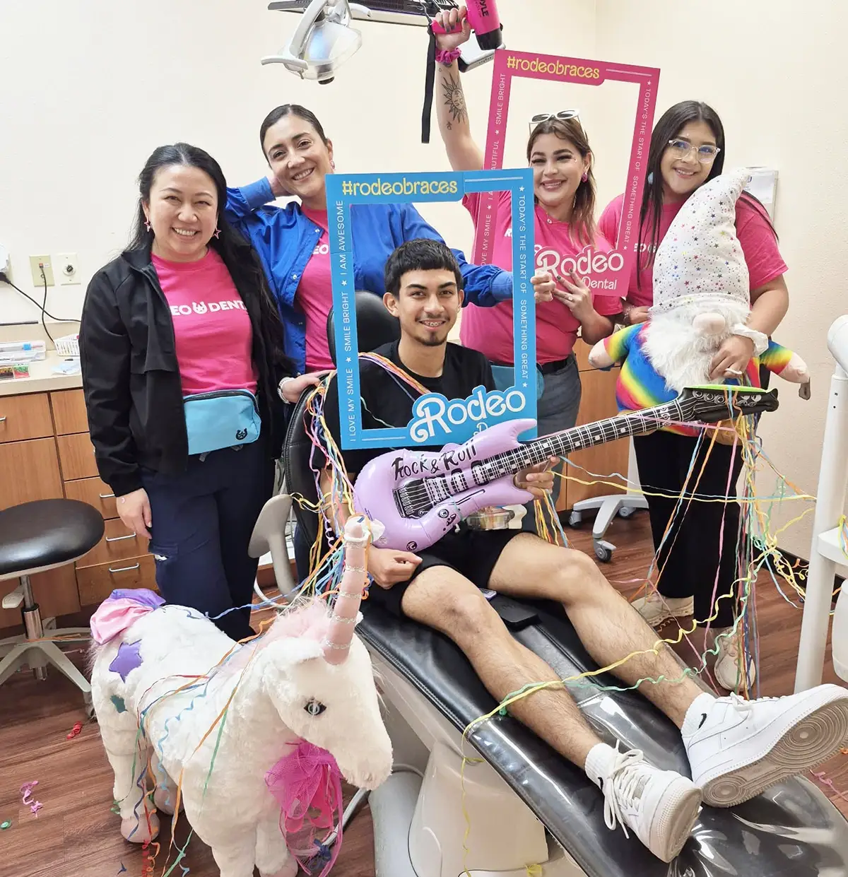 Patient celebrating braces with Rodeo Dental team