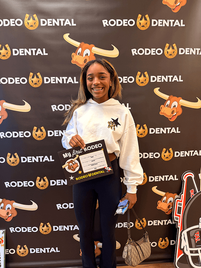Teen with braces smiling at Rodeo Dental
