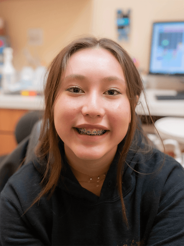 Orthodontist examining teen with braces during checkup