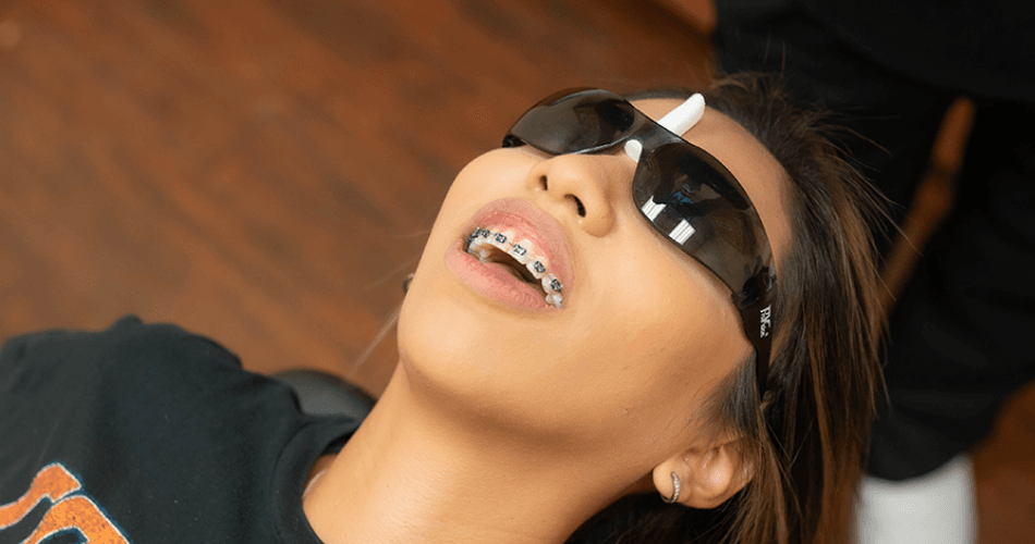 Smiling patient with braces at Rodeo Dental office