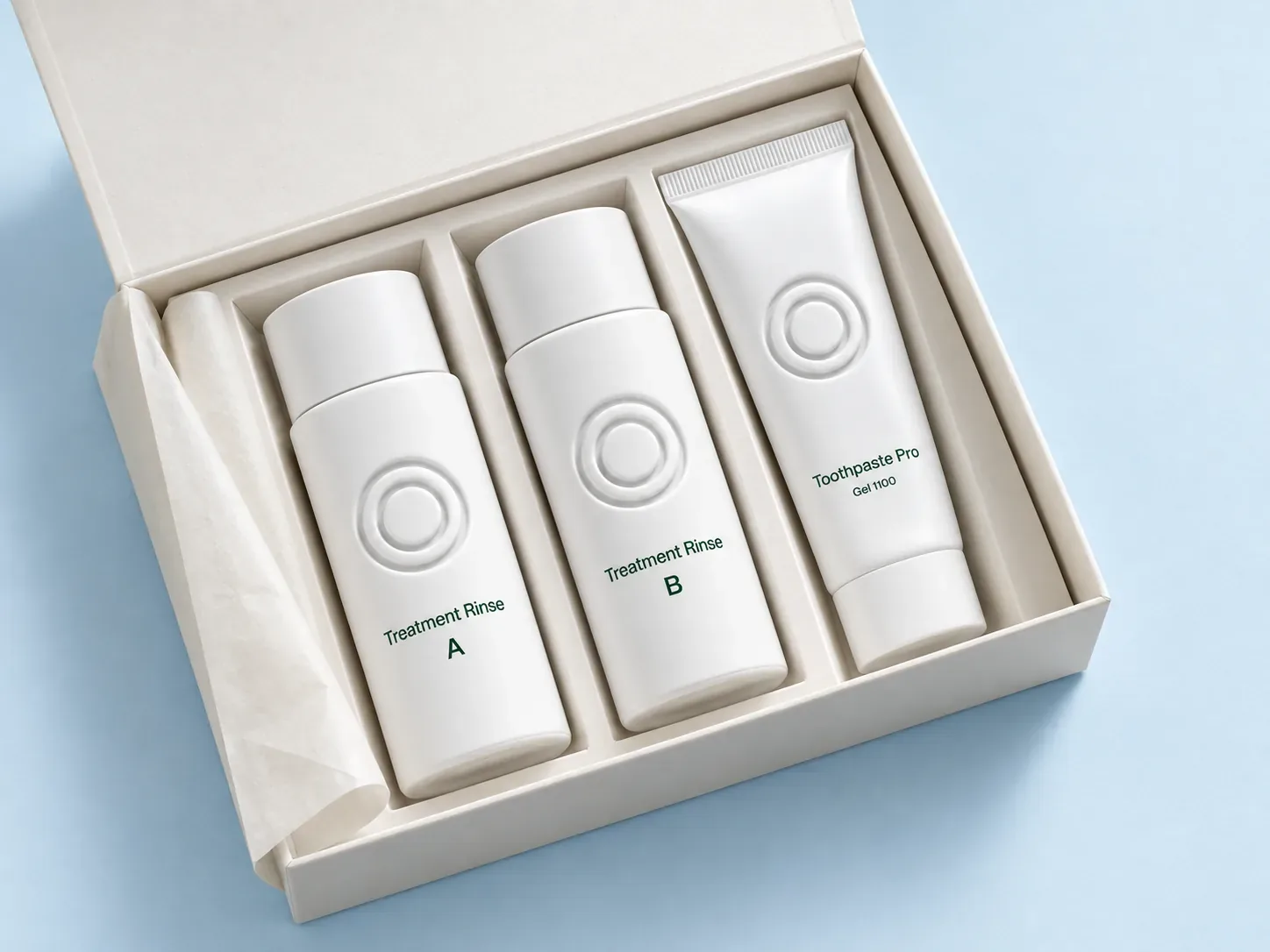 An open white care box with two Treatment Rinse bottles and a Toothpaste Pro tube on a pale blue surface