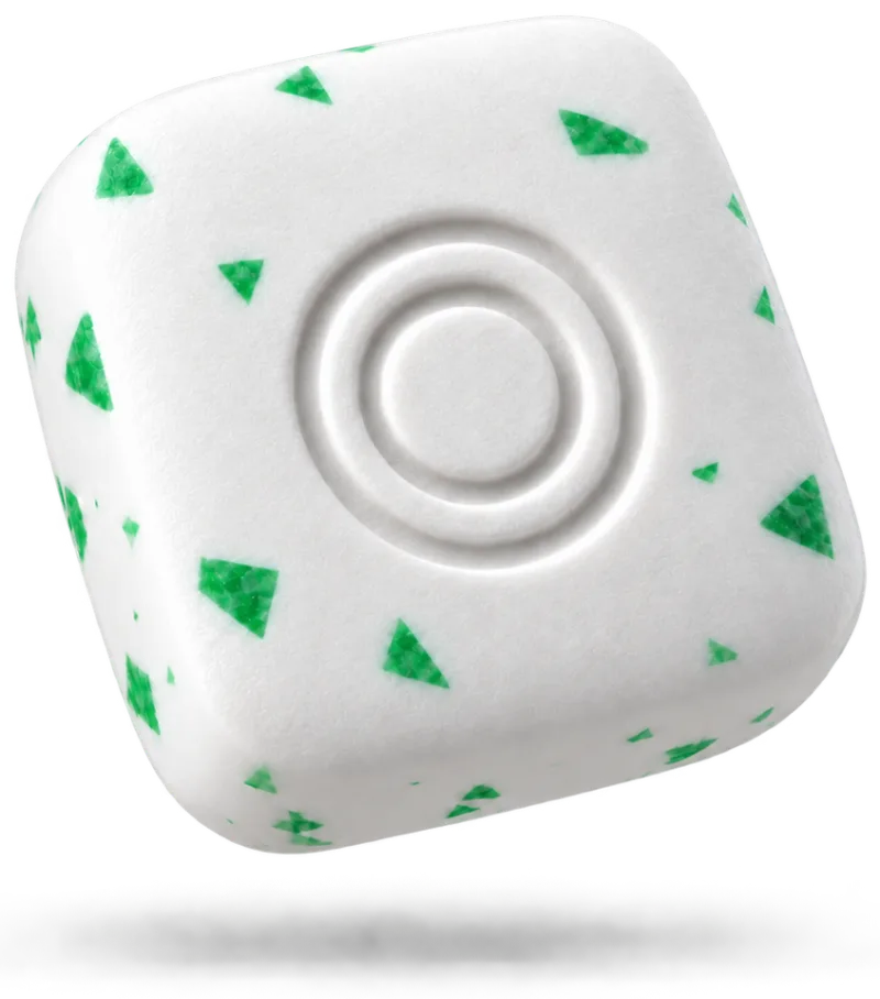 A square piece of gum, white with green mint flecks and the OneOral ring pressed into it